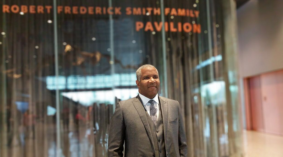 Robert F. Smith standing outside of the Robert Frederick Smith Family Pavilion at the National Museum of African American History and Culture