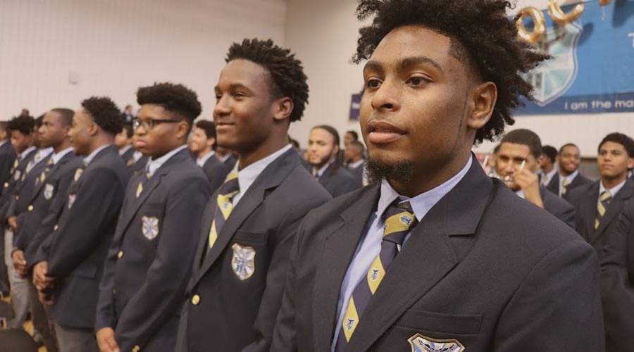 Male Eagle Academy students line up in uniforms