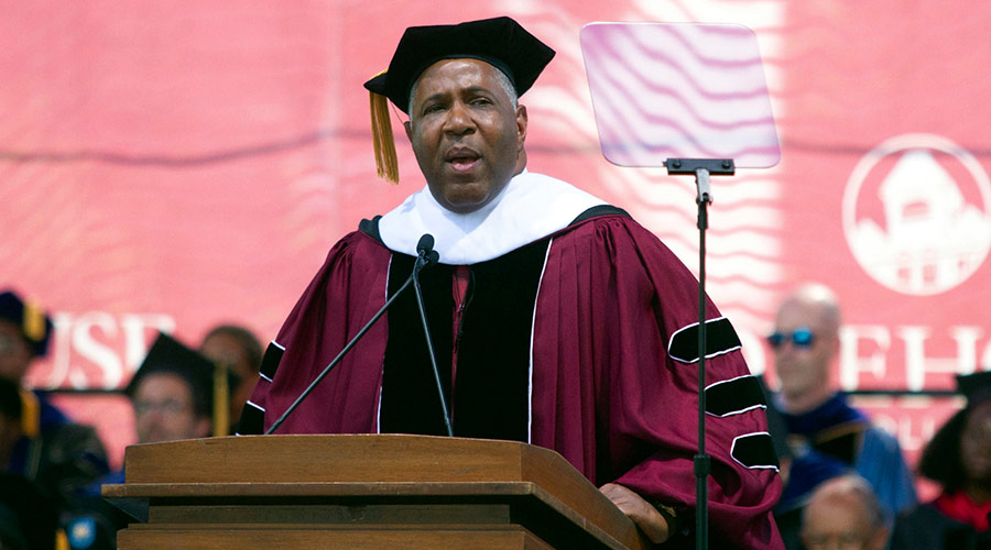 Robert F. Smith, dressed in a graduation cap and gown, giving the commencement speech at Morehouse College in 2019