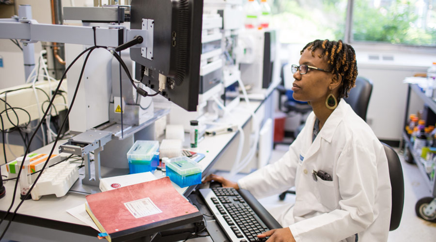 Albert Einstein College of Medicine student in a white lab coat working in a clinical setting.