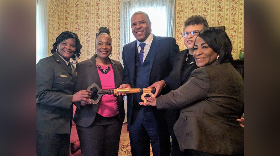 Robert F. Smith, Bernice King, Linda Wilson and Angela Christine Farris Watkins with a large, ceremonial key in the King family home in Atlanta.