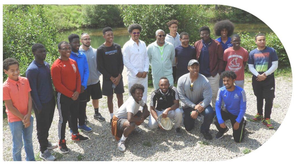 Philanthropist Robert F. Smith outside with a large group of African American children