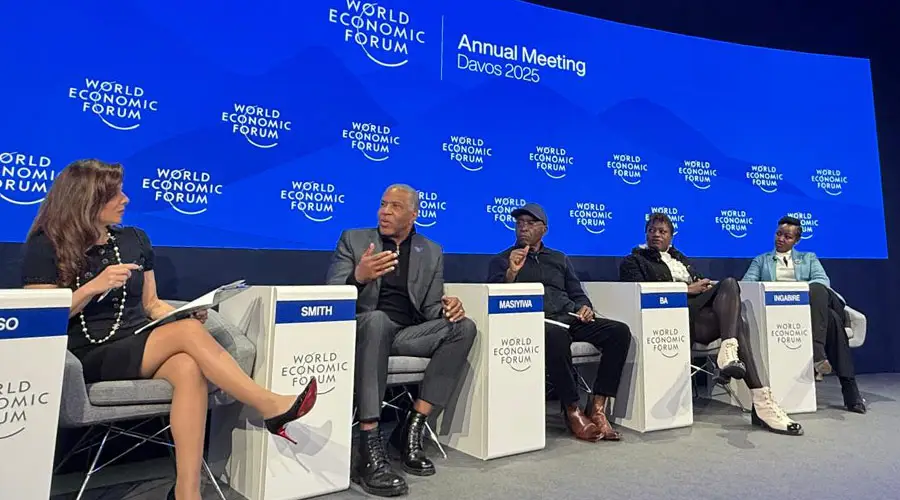 The 2025 World Economic Forum panelists sit on stage as they speak in Davos, Switzerland